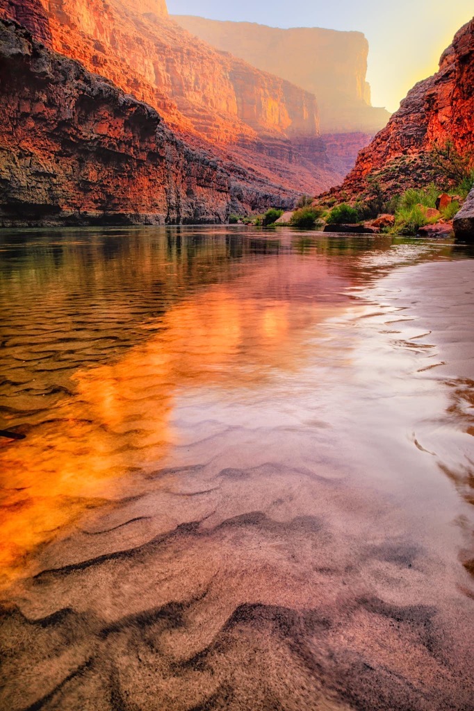 a steady body of water inside a red canyon